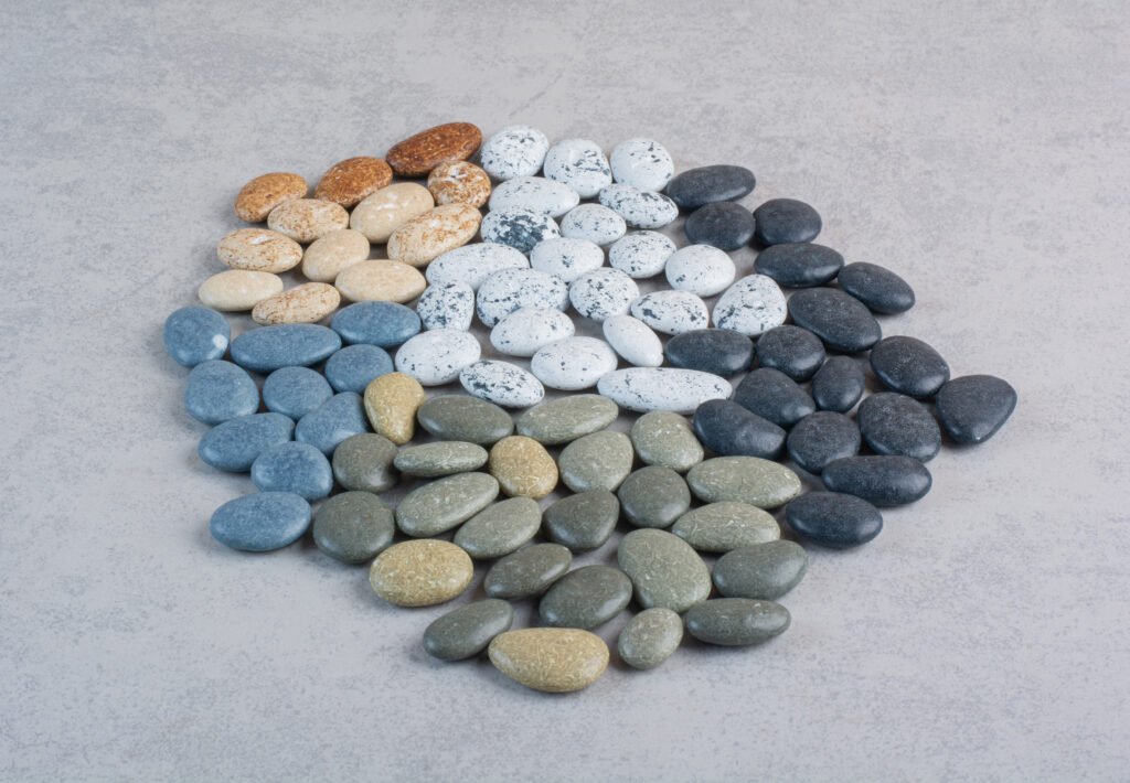 colorful decorative stones for crafting on concrete background